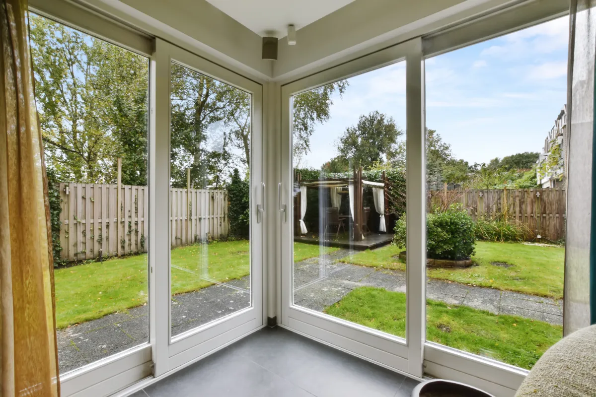 Bright sliding doors with garden view and wooden gazebo