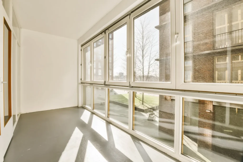 Bright and spacious room with modern white windows and natural sunlight